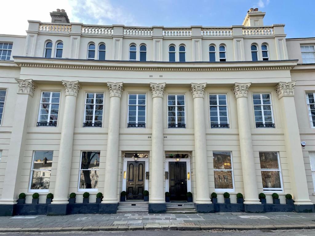 "Regency House in Belfast, featuring it's Georgian style facade with symmetrical windows, decorative stonework and a formal entrance".